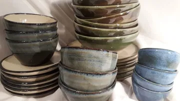 Bowls and plates are stacked and arranged on top of each other.