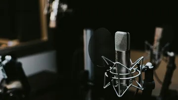 The microphone is on the table, surrounded by low light.