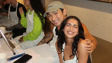 Smiling people sit at a table in a restaurant.
