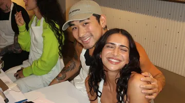 Smiling couple sitting in a bright, friendly room.