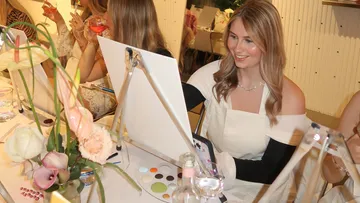 A painter creates a painting in a convivial environment.