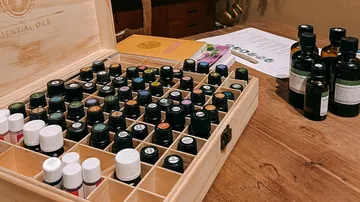 Wooden box with essential oils arranged on a table