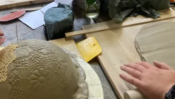 Pottery tools form wet clay on a table