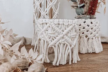 Macrame-decorated vases with dried flowers.