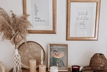 Framed quotes and decor on wooden table.