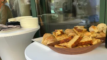 Bread and rolls on a table at an event.