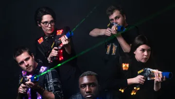 Five people aim at black with laser guns.