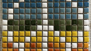 Colorful tiles form a pattern on a surface.