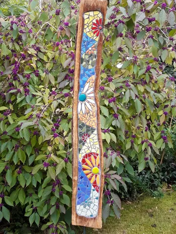 Colourful mosaic panel depicts floral patterns between green leaves