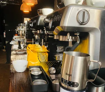 Coffee bar with machines that make drinks. wood surface.