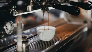 A coffee mug is filled with freshly brewed coffee.