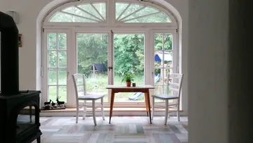 Small table and chairs by large window
