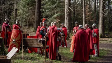 Group of Roman soldiers in forest.