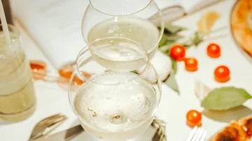 Two wine glasses on a dinner table.