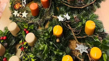 Christmas wreaths with candles on table