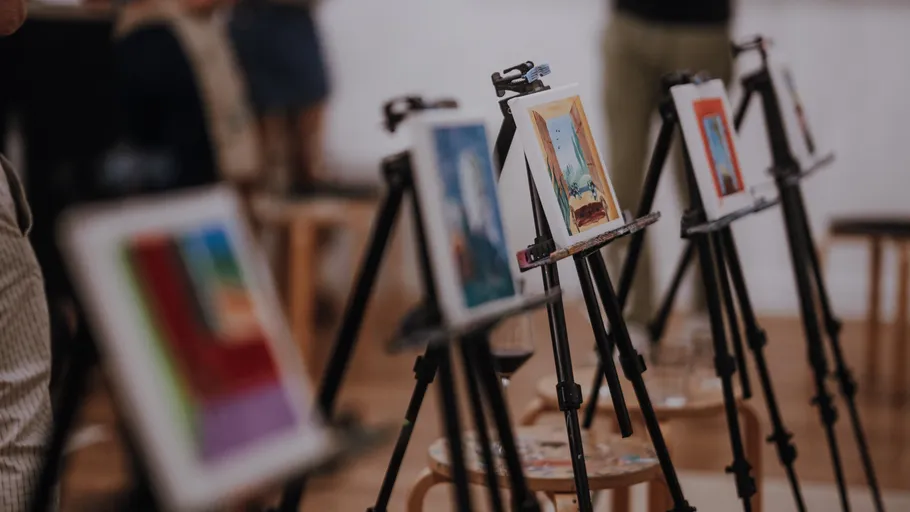 Paintings on easels in an art studio.