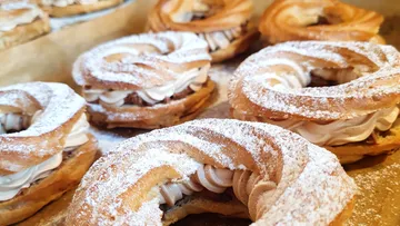 Cream-filled pastries dusted with powdered sugar.