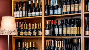 Shelf of assorted wine bottles in a store.