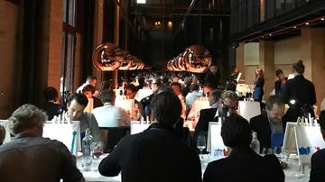 People dining at a long, elegantly set table.