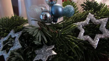 Christmas decorations with silver stars on pine branches.