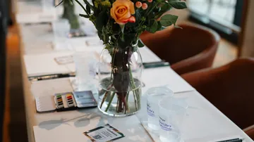 Blumenvase auf dem Tisch mit Künstlerbedarf.