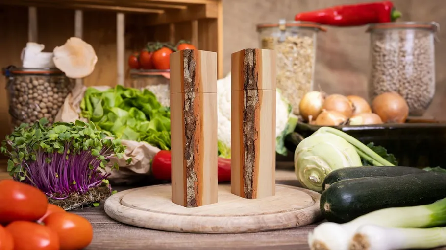 Two wooden salt and pepper mills on kitchen counter.