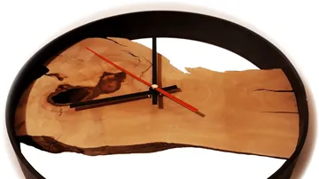 Wood and metal wall clock with red hands.