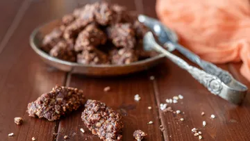Chocolate clusters on wooden table surface.