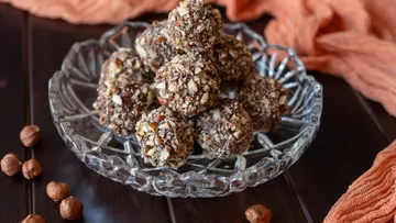 Hazelnut chocolate truffles in glass dish on table.
