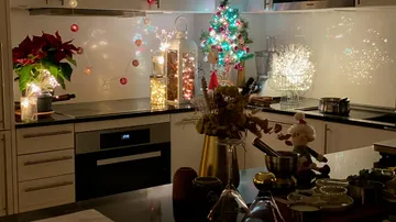 Festliche Küche mit Weihnachtsschmuck und Lichtern.
