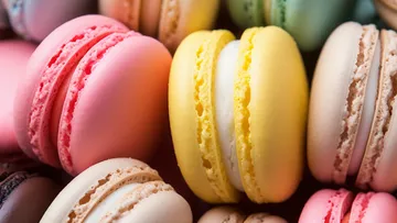 Colorful macarons stacked closely together.