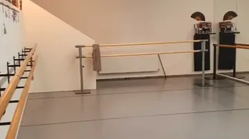 Leeres Ballettstudio mit Spiegeln und Gittern.