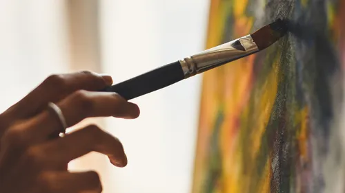 Hand painting on canvas with brush.