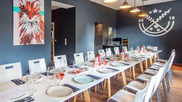 Elegant dining room with long table and art.