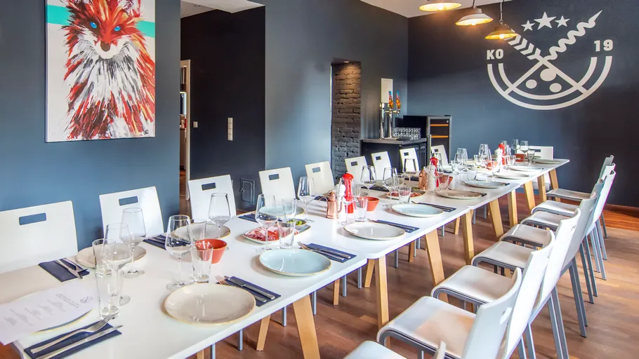 Elegant dining room with modern decor, artwork, and set table.