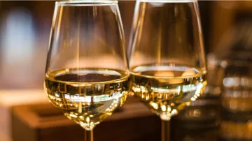 Zwei Gläser Weißwein auf dem Tisch.