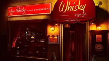 Whisky piano bar exterior with red signage.