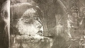 Face-like pattern on frosted glass surface.