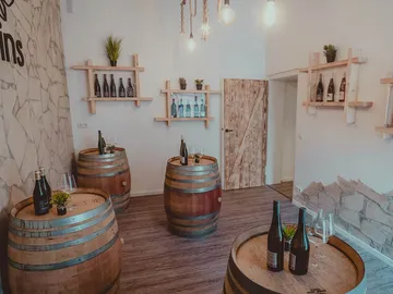 Barrels are in a modernly designed room with shelves.