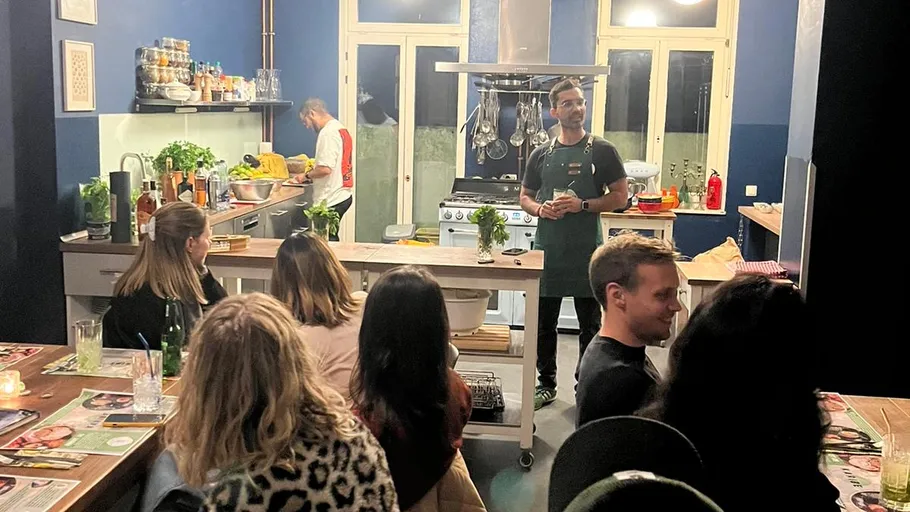 Person teaching cooking class in kitchen setting.