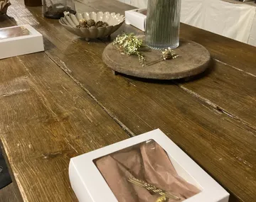 Wooden table with decorative items and boxes.