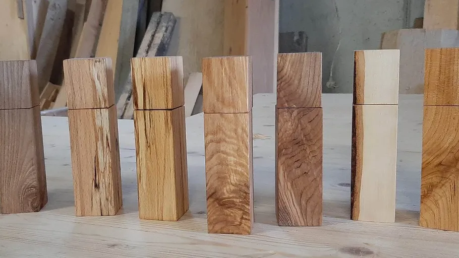 Wooden perfume bottles on a wooden table.