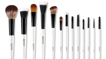 Set of makeup brushes with white handles.