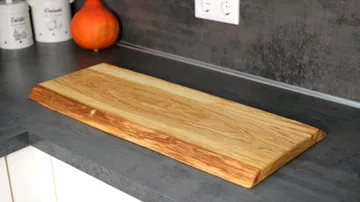 Wooden cutting board on kitchen counter.