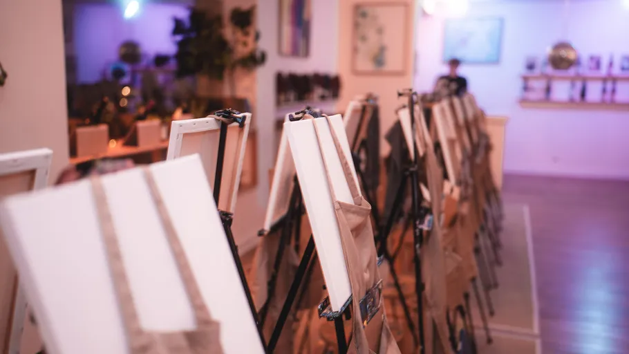 Empty easels in art studio with dim lighting.