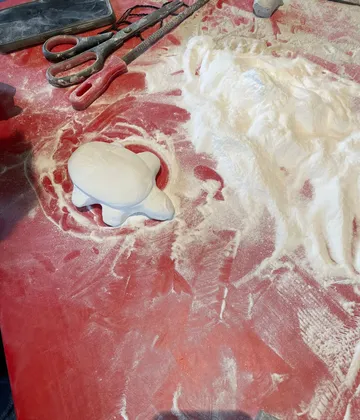 Sculpted turtle amidst powdered tools