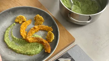 Pumpkin slices with green sauce on plate
