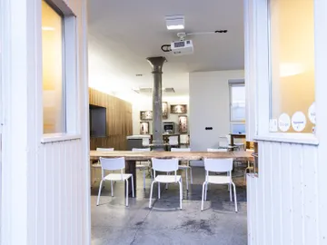 A table is in a neutral room with chairs.