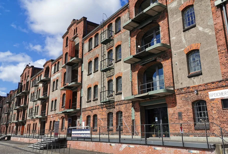 Old brick warehouse building with balconies.