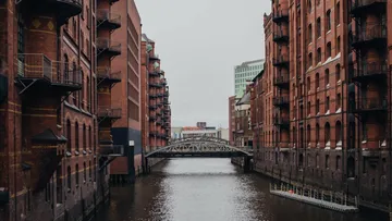 Narrow canal with red brick buildings.
